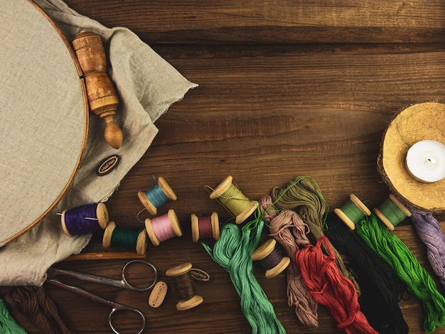 embroidery threads and tools on wooden table