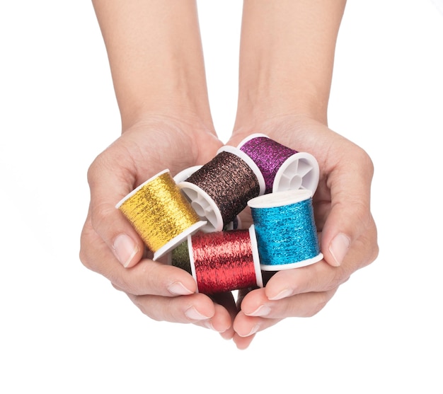 hands stitching colorful thread